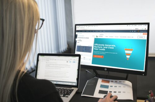 woman sitting in front of turned-on computer monitor