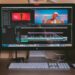 turned on iMac and Apple Magic Keyboard and mouse on table