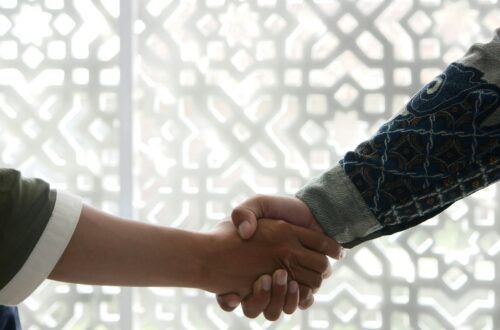 a close up of two people shaking hands